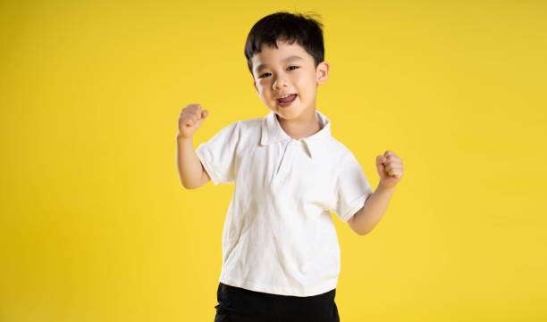 image of asian boy posing on a yellow background