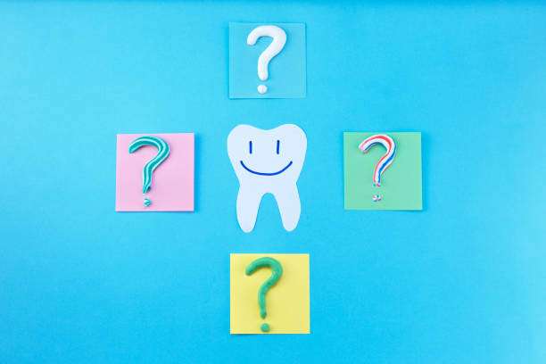 Symbol of question mark from toothpaste on blue background, toothpaste selection concept. Concept of dental care. Cleaning teeth