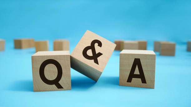Q and A abbreviations on wooden block surface with engraved effect of letters Q and A.