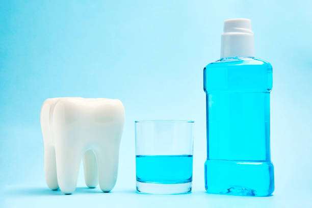 Dental oral hygiene concept. Oral rinse for mouth and teeth wash, background with copy space, close-up. Dental health care