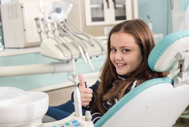Beautiful girl in dentist office smiling